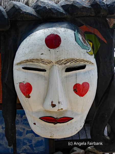 wooden mask at village entrance