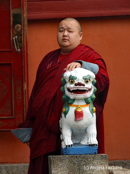 monk with hand on statue