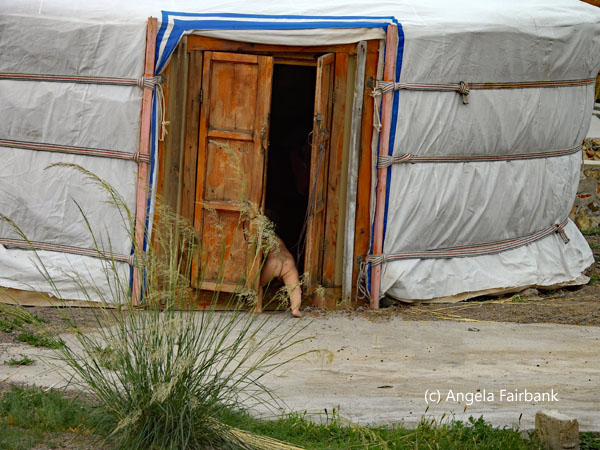 naked baby slipping into ger