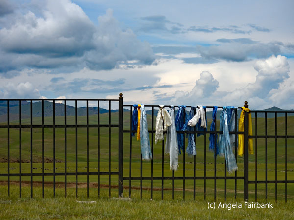 prayer scarfs on fence