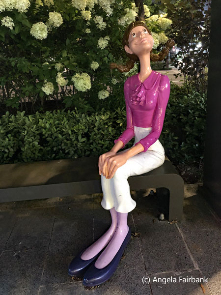 plastic statue on bus bench