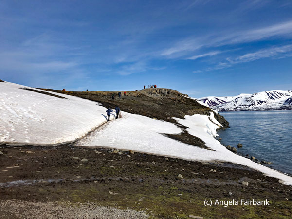 hikers walking over snow