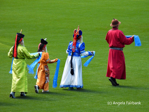 four people carrying scarves
