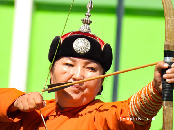 female archer in orange