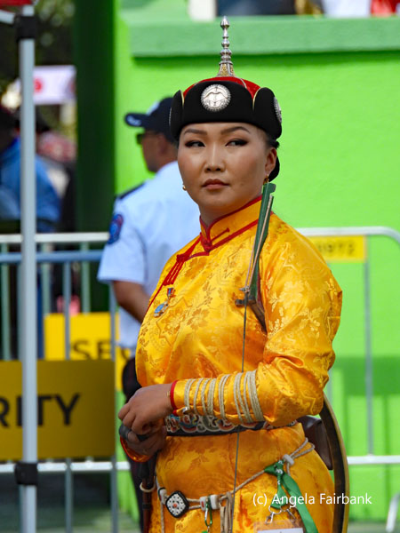 female archer in yellow