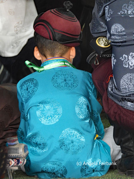 boy in turquoise tunic