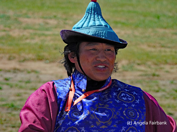 woman judge in turqouise hat