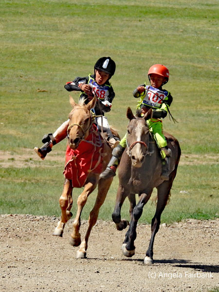two riders with black and red helmets