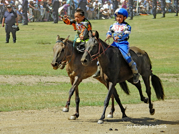 two riders one without helmet the other with blue helmet