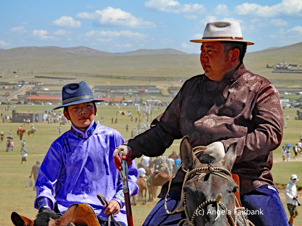 father and son in hats on horses