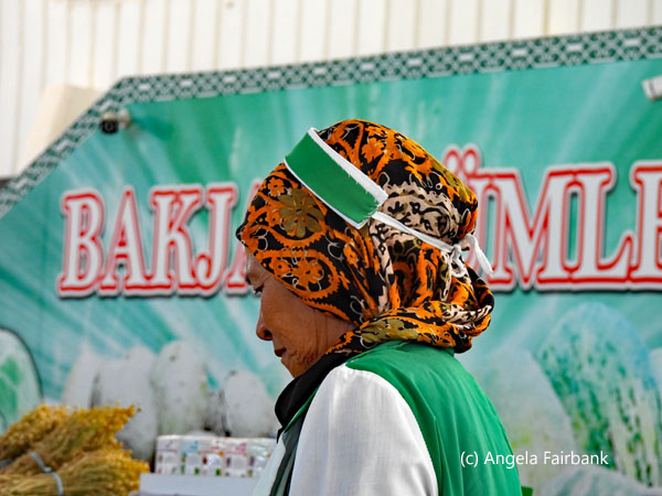market vendor in orange and green
