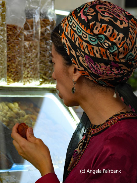 market visitor tasting a grape