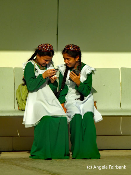 two girls in school uniform at bus stiop