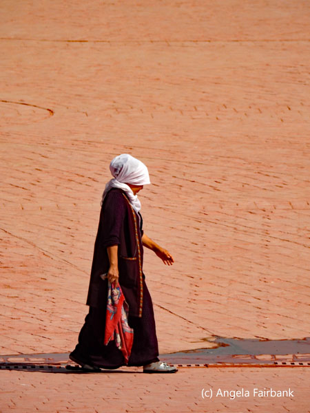 woman crossing square with white headscarf