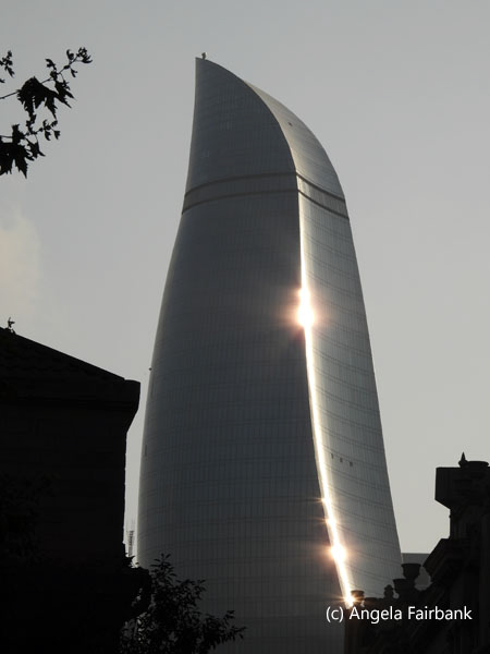 flame tower and reflection of sun
