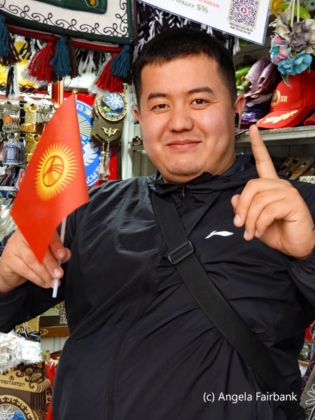 vendor holding Kyrgyzstan flag