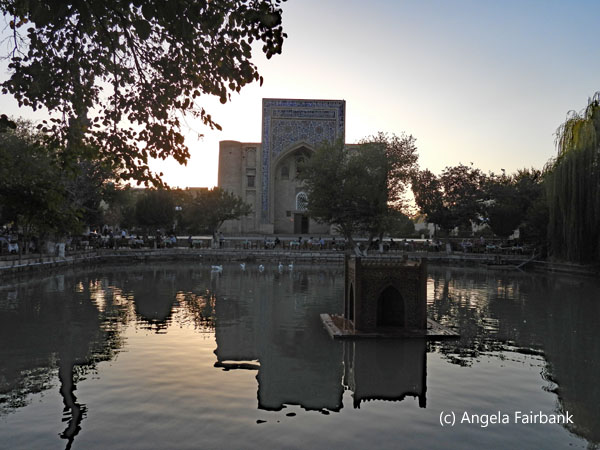 building and pond at sunset