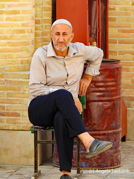 man sitting by oil drum