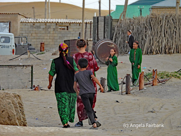 two women, two irls, two boys in village