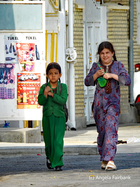 2 school girls walking across road