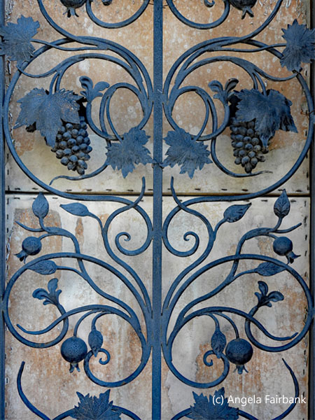 gate decorated with grapes and pomegranates