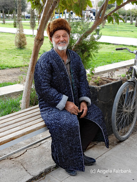 man on bench with bicycle