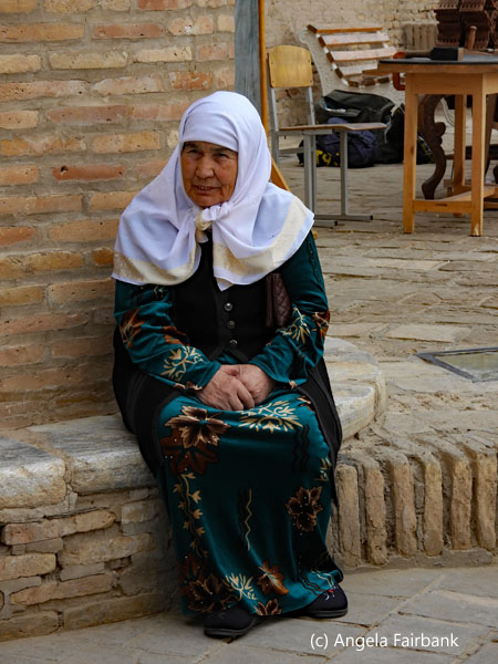 woman in white head scarf sitting