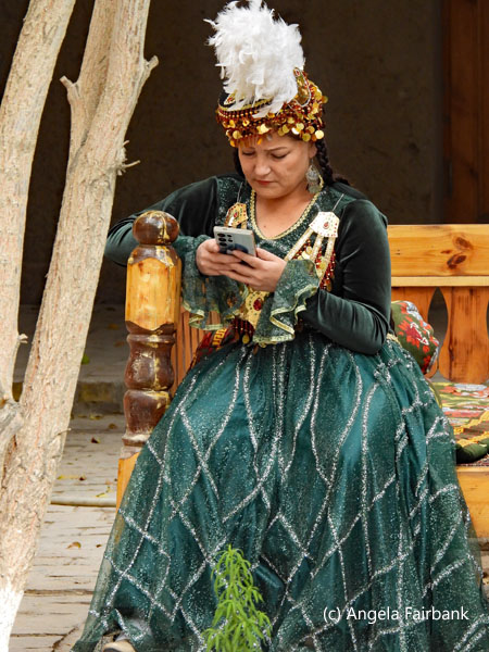 seated dancer on cell phone