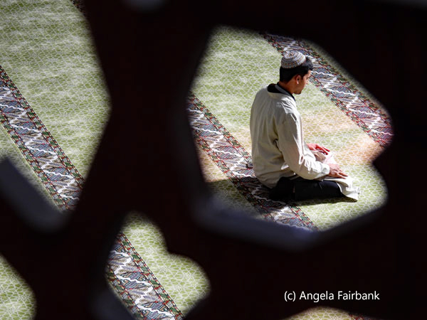 view of man praying from women area of mosque 3