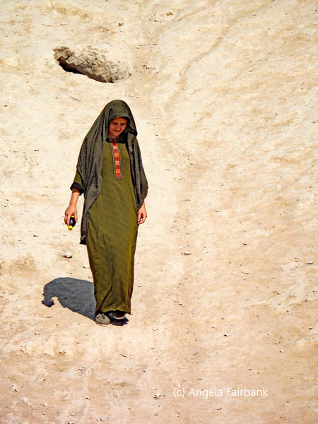 woman climbing down from castle hill