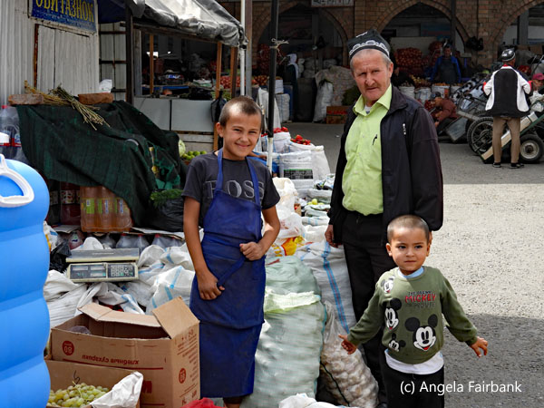 old man and two boys at market