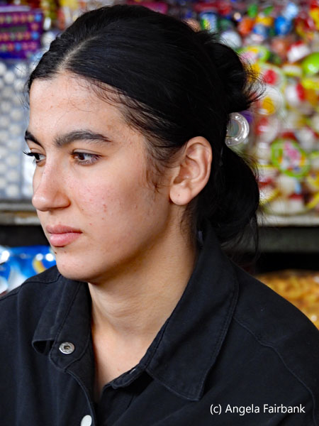young woman vendor with bare head