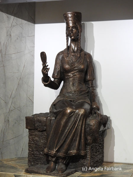 tall statue of ancient woman in museum