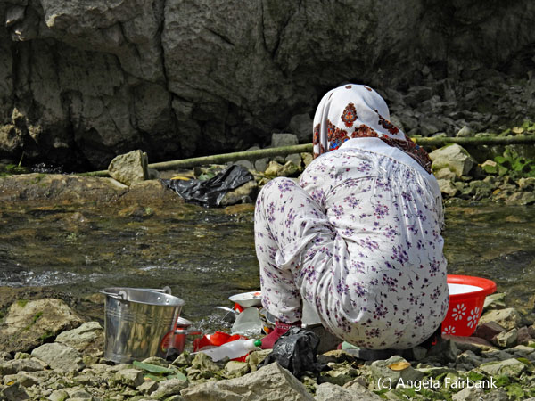 washing dishes in the stream