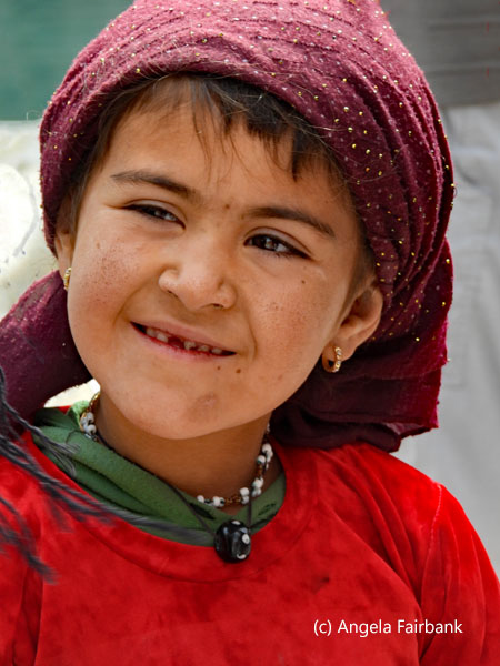 girl in red top and purple headscarf