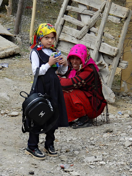 old lady squatting and school girl