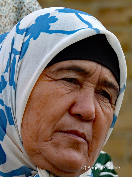 older woamn in blue and white headscarf
