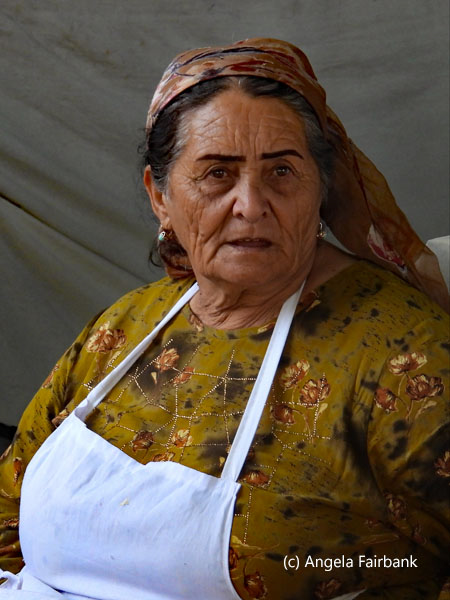 large older woman in white apron