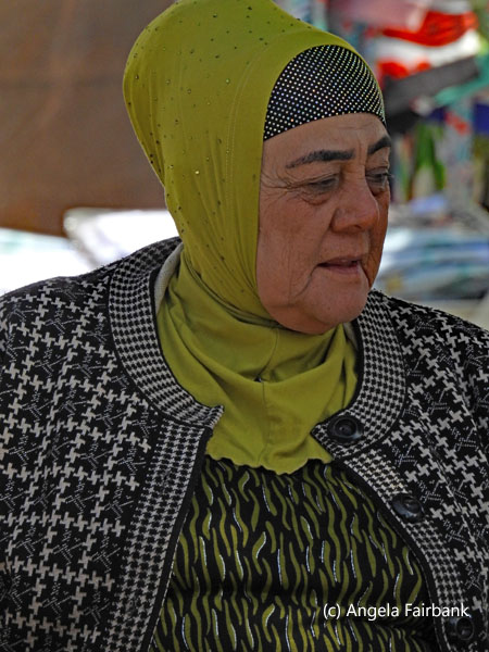 older woman in green and black