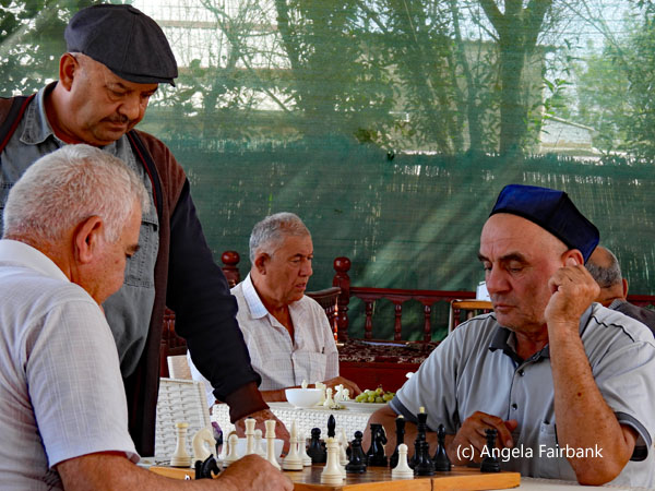 men playing chess in restaurant