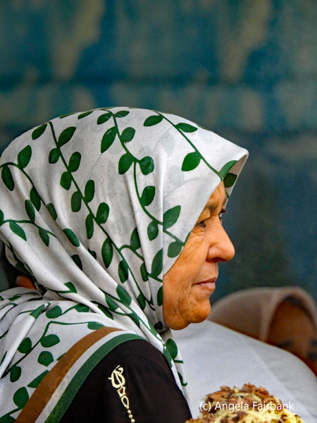 woman in green and white headscarf