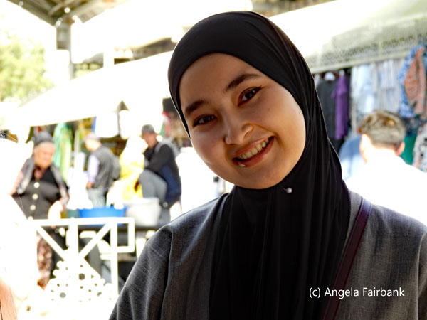 smiling young woman in black headscarf