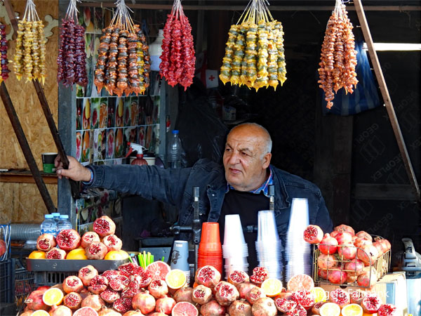 pomegranate juice seller with candied walnuts etc