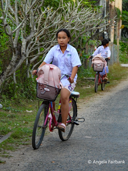 school girls on bicycles