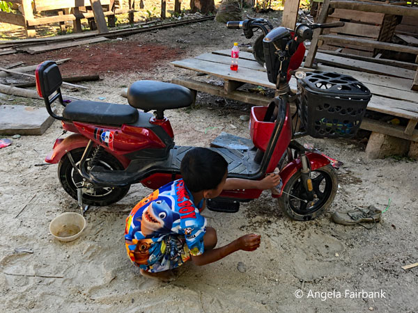 boy repairing his bike