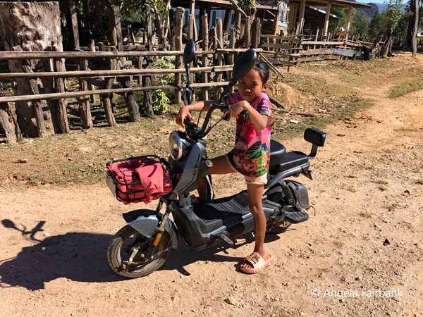 little Phu Thai girl on scooter