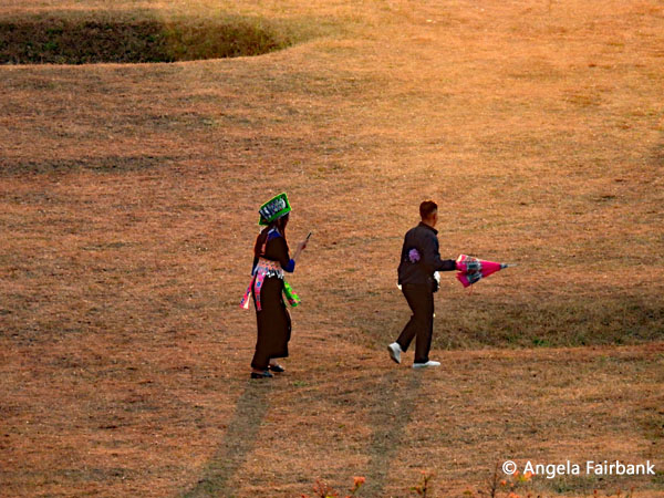 young couple in hilltribe clothing at sunset