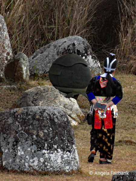 middel aged owman in hilltribe wear at plin of jars