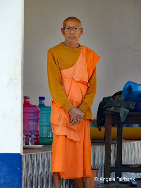 monk standing with hands in front