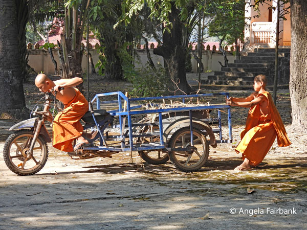two monks manipulating a cart